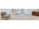 Relaxing living room featuring a rocking chair, neutral carpeting, and bright french doors at 6851 Roswell Rd # H1, Sandy Springs, GA 30328