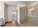 Bathroom featuring shower with tile surround and wood-look floors at 731 Hedwig Dr, Mcdonough, GA 30252