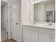 Bright bathroom with double vanity, white cabinets, and modern fixtures at 731 Hedwig Dr, Mcdonough, GA 30252