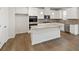 Modern kitchen boasts granite counters, an island, stainless appliances, and hardwood flooring at 731 Hedwig Dr, Mcdonough, GA 30252