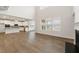 Open-concept living area with hardwood floors, fireplace, and bright kitchen view at 731 Hedwig Dr, Mcdonough, GA 30252