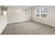 Loft area with neutral carpet and a bright window at 731 Hedwig Dr, Mcdonough, GA 30252