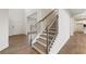 Elegant staircase with wood treads, black iron railings, and wood floors in foyer at 731 Hedwig Dr, Mcdonough, GA 30252