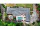 Expansive house from aerial view, showcasing the pool, patio, and lush green landscaping with surrounding trees at 168 Woodland Valley Rd, Lawrenceville, GA 30046