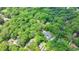 Wide aerial view showcasing a private home nestled among dense trees, offering a sense of seclusion and natural beauty at 168 Woodland Valley Rd, Lawrenceville, GA 30046