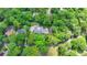 Aerial view of the property, nestled among mature trees, showcasing the house, pool, and surrounding landscape at 168 Woodland Valley Rd, Lawrenceville, GA 30046