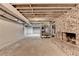 Unfinished basement with exposed brick chimney, exposed ceiling, and ample potential for customization at 168 Woodland Valley Rd, Lawrenceville, GA 30046