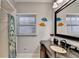 Bright bathroom showcases a vanity with granite countertop, decorative mirror, and tiled shower at 168 Woodland Valley Rd, Lawrenceville, GA 30046