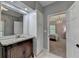 Bathroom with a granite vanity, large mirror, and view of the bedroom at 168 Woodland Valley Rd, Lawrenceville, GA 30046