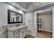 Bathroom features wood tile floors, granite counters, decorative stone backsplash and a shelving unit at 168 Woodland Valley Rd, Lawrenceville, GA 30046