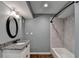 Well-lit bathroom featuring granite countertops, shower, and modern tub at 168 Woodland Valley Rd, Lawrenceville, GA 30046