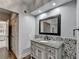 Bathroom features wood tile floors, granite counters, decorative stone backsplash, with passage to main bedroom at 168 Woodland Valley Rd, Lawrenceville, GA 30046