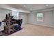 Spacious bedroom with a game simulator, two windows with blinds, neutral paint, and plush carpeting at 168 Woodland Valley Rd, Lawrenceville, GA 30046