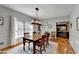 This dining room features hardwood floors, natural light, and a view of the kitchen at 168 Woodland Valley Rd, Lawrenceville, GA 30046