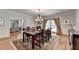 Elegant dining room with hardwood floors, a large table, and a view into the living room, perfect for entertaining at 168 Woodland Valley Rd, Lawrenceville, GA 30046