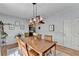 Light-filled dining room features wood table, modern lighting, and neutral walls, perfect for gatherings at 168 Woodland Valley Rd, Lawrenceville, GA 30046