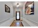 Inviting entryway with decorative door, hardwood floors, bench, and stylish lighting at 168 Woodland Valley Rd, Lawrenceville, GA 30046