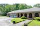 Brick home featuring arched entryways, a spacious driveway, and attached garages, blending charm and functionality at 168 Woodland Valley Rd, Lawrenceville, GA 30046