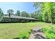 Charming brick ranch-style home with a sprawling lawn and mature trees offering a tranquil and inviting curb appeal at 168 Woodland Valley Rd, Lawrenceville, GA 30046