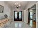 Elegant foyer with a chandelier, decorative tile flooring, and stylish doors creating a grand entrance at 168 Woodland Valley Rd, Lawrenceville, GA 30046