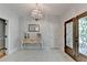 Elegant foyer featuring a crystal chandelier and black and white tiled floor, adding a touch of sophistication at 168 Woodland Valley Rd, Lawrenceville, GA 30046