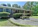 Beautiful home with a well-manicured lawn, mature bushes, fountain, and a charming entrance at 168 Woodland Valley Rd, Lawrenceville, GA 30046