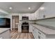 White kitchen cabinets, stainless steel appliances, and stone countertops at 168 Woodland Valley Rd, Lawrenceville, GA 30046