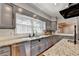 Stylish kitchen featuring granite countertops, stainless steel appliances, and ample natural light creating a modern cooking space at 168 Woodland Valley Rd, Lawrenceville, GA 30046