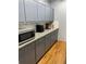 The gray kitchen features granite countertops, cabinets, and stainless steel microwave at 168 Woodland Valley Rd, Lawrenceville, GA 30046