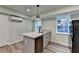 Kitchen island with granite counters, sink and gray cabinets plus stainless steel dishwasher at 168 Woodland Valley Rd, Lawrenceville, GA 30046