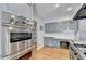 A stainless steel Viking oven stands out in this updated kitchen with gray cabinets and hardwood floors at 168 Woodland Valley Rd, Lawrenceville, GA 30046