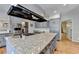 Well-equipped kitchen with a large island, granite countertops, and modern appliances for culinary enthusiasts at 168 Woodland Valley Rd, Lawrenceville, GA 30046
