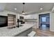 Cozy kitchen with granite countertops, white cabinets, stainless steel appliances, and an adjacent dining area at 168 Woodland Valley Rd, Lawrenceville, GA 30046