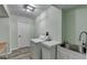 Bright laundry room featuring a sink and modern washing machine at 168 Woodland Valley Rd, Lawrenceville, GA 30046