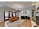 A stylish living room features hardwood floors, a fireplace, and French doors leading outside at 168 Woodland Valley Rd, Lawrenceville, GA 30046
