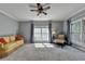 Bright living room with cozy seating, large windows, and neutral decor offers a comfortable living space at 168 Woodland Valley Rd, Lawrenceville, GA 30046
