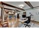 Spacious living room with beamed ceilings, hardwood floors, stone fireplace, and comfortable seating at 168 Woodland Valley Rd, Lawrenceville, GA 30046