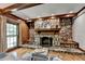 Cozy living room featuring a stone fireplace, wood accents, and natural light is great for relaxation at 168 Woodland Valley Rd, Lawrenceville, GA 30046