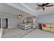 Spacious bedroom features neutral colors, ceiling fans, and a sitting area with a comfortable sofa at 168 Woodland Valley Rd, Lawrenceville, GA 30046