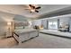 Spacious main bedroom suite with a seating area, plush carpet, and plenty of natural light is great for relaxation at 168 Woodland Valley Rd, Lawrenceville, GA 30046