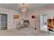 Bright home office with pink walls, carpet, and a charming chandelier at 168 Woodland Valley Rd, Lawrenceville, GA 30046
