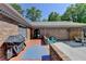 Outdoor brick patio with a grill and pergola-covered seating area is perfect for outdoor entertaining at 168 Woodland Valley Rd, Lawrenceville, GA 30046