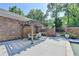 A pergola-covered outdoor patio with dining area and brick walls offers a perfect space for outdoor entertaining at 168 Woodland Valley Rd, Lawrenceville, GA 30046