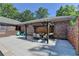 The pergola-covered patio and outdoor seating create a welcoming extension of the brick home at 168 Woodland Valley Rd, Lawrenceville, GA 30046
