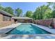 Backyard pool with pergola, brick fence, and garden pots create a serene outdoor living space at 168 Woodland Valley Rd, Lawrenceville, GA 30046
