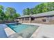 Backyard pool with tiled edge and concrete patio is perfect for relaxing and enjoying the outdoors at 168 Woodland Valley Rd, Lawrenceville, GA 30046