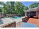 A secluded backyard pool offers a private retreat with brick accents and access to the screened-in porch at 168 Woodland Valley Rd, Lawrenceville, GA 30046