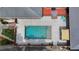 Aerial view of a sparkling in-ground pool, surrounded by a patio, lounge chairs, and well-maintained landscaping at 168 Woodland Valley Rd, Lawrenceville, GA 30046