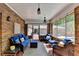 Inviting sunroom with brick accents, comfortable seating, and views of the lush backyard, perfect for relaxing and entertaining at 168 Woodland Valley Rd, Lawrenceville, GA 30046