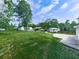Expansive backyard featuring lush green lawn, mature trees, and a charming detached garage at 2660 Birch Se St, Smyrna, GA 30080